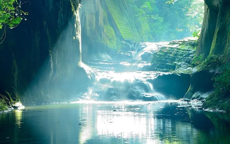 Sunlit waterfall cave landscape for max-side fit